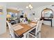 Bright dining room with a wooden table and white chairs at 5697 Sheffield Greene Cir # 51, Sarasota, FL 34235