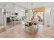 Bright dining room with table and chairs, mirrored wall, and view into kitchen at 5697 Sheffield Greene Cir # 51, Sarasota, FL 34235