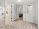 Bright entryway with tiled floor, linen closet, and view into bedroom at 5697 Sheffield Greene Cir # 51, Sarasota, FL 34235