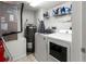 Bright laundry room, featuring washer, dryer, and shelving at 5697 Sheffield Greene Cir # 51, Sarasota, FL 34235