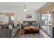 Spacious living room with gray sofas, coffee table, and access to patio at 5697 Sheffield Greene Cir # 51, Sarasota, FL 34235