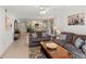 Open living room with gray sofas, coffee table, and view of dining area at 5697 Sheffield Greene Cir # 51, Sarasota, FL 34235