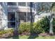 Private screened patio with seating, surrounded by lush landscaping at 5697 Sheffield Greene Cir # 51, Sarasota, FL 34235