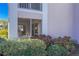 Screened patio with seating area, lush landscaping, and a view of the community at 5697 Sheffield Greene Cir # 51, Sarasota, FL 34235