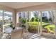 Screened patio with table and chairs, offering view of lush landscaping at 5697 Sheffield Greene Cir # 51, Sarasota, FL 34235