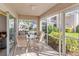 Relaxing screened patio with outdoor furniture and view of community at 5697 Sheffield Greene Cir # 51, Sarasota, FL 34235