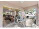 Enjoy the screened patio with table and chairs and view of the living room at 5697 Sheffield Greene Cir # 51, Sarasota, FL 34235