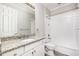 Bathroom with granite countertop, white cabinets, and shower/tub combo at 6010 Anise Dr, Sarasota, FL 34238