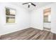 Bright bedroom with wood-look floors and access to bathroom at 6010 Anise Dr, Sarasota, FL 34238