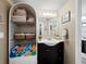 Clean bathroom with dark vanity and shelving at 605 Sutton Pl # 205, Longboat Key, FL 34228