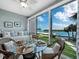 Bright dining area with water views and seating for four at 605 Sutton Pl # 205, Longboat Key, FL 34228