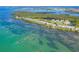 Aerial view of waterfront homes and lush landscape at 61 Tidy Island Blvd, Bradenton, FL 34210