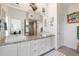 Double vanity bathroom with granite countertops and a large mirror at 61 Tidy Island Blvd, Bradenton, FL 34210