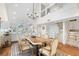 Open concept dining room with hardwood floors, a live-edge table, and loft views at 61 Tidy Island Blvd, Bradenton, FL 34210