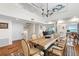 Open concept dining room with hardwood floors, a live-edge table, and loft views at 61 Tidy Island Blvd, Bradenton, FL 34210