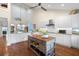 Modern kitchen featuring white cabinets, granite counters, and a center island at 61 Tidy Island Blvd, Bradenton, FL 34210