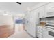 Kitchen with white appliances and view to living room at 6514 Bowdoin Pl, Bradenton, FL 34207