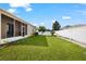 Backyard with screened patio and lawn at 7308 Tangle Bend Dr, Gibsonton, FL 33534