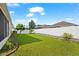 Landscaped backyard with grassy lawn at 7308 Tangle Bend Dr, Gibsonton, FL 33534