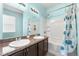 Bathroom with double vanity, tub/shower combo, and a stylish shower curtain at 7308 Tangle Bend Dr, Gibsonton, FL 33534