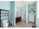 Bright bathroom with double vanity, tub shower combo, and light blue walls at 7308 Tangle Bend Dr, Gibsonton, FL 33534