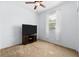 Spacious bedroom with ceiling fan, large TV, and neutral carpet at 7308 Tangle Bend Dr, Gibsonton, FL 33534