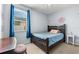 Well-lit bedroom with a full bed and window at 7308 Tangle Bend Dr, Gibsonton, FL 33534