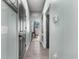 Long hallway with gray doors and wood-look floors at 7308 Tangle Bend Dr, Gibsonton, FL 33534