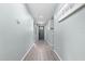 Bright hallway with gray door and wood-look floors at 7308 Tangle Bend Dr, Gibsonton, FL 33534