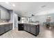 Open concept kitchen with island, gray cabinets, and breakfast nook at 7308 Tangle Bend Dr, Gibsonton, FL 33534