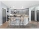 Modern kitchen with gray cabinets, granite countertops and breakfast bar at 7308 Tangle Bend Dr, Gibsonton, FL 33534