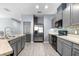 Modern kitchen with gray cabinets, stainless steel appliances, and mosaic backsplash at 7308 Tangle Bend Dr, Gibsonton, FL 33534