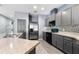Modern kitchen with gray cabinets, stainless steel appliances, and mosaic backsplash at 7308 Tangle Bend Dr, Gibsonton, FL 33534