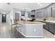 Modern kitchen with gray cabinets, granite countertops and breakfast bar at 7308 Tangle Bend Dr, Gibsonton, FL 33534