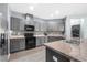 Modern kitchen with gray cabinets, stainless steel appliances, and mosaic backsplash at 7308 Tangle Bend Dr, Gibsonton, FL 33534
