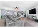 Open living room with gray sectional sofa and kitchen views at 7308 Tangle Bend Dr, Gibsonton, FL 33534