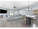 Open concept living and dining area with gray sectional and dining table at 7308 Tangle Bend Dr, Gibsonton, FL 33534
