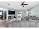Open living room with sliding glass doors and gray sectional sofa at 7308 Tangle Bend Dr, Gibsonton, FL 33534