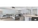 Spacious living room with gray sectional sofa and wood-look floors at 7308 Tangle Bend Dr, Gibsonton, FL 33534