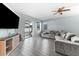 Living area with gray sectional sofa, large TV, and sliding doors to patio at 7308 Tangle Bend Dr, Gibsonton, FL 33534