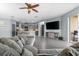 Open living area with gray sectional sofa and views into kitchen at 7308 Tangle Bend Dr, Gibsonton, FL 33534