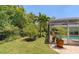 Landscaped backyard with lush tropical plants and a pool at 7331 Westmoreland Dr, Sarasota, FL 34243