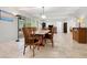 Bright dining area with wood table and chairs, open to the kitchen at 7331 Westmoreland Dr, Sarasota, FL 34243