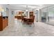 Bright dining room features tile flooring and view into kitchen at 7331 Westmoreland Dr, Sarasota, FL 34243