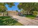House exterior showcasing a two-car garage, and a well-manicured lawn at 7331 Westmoreland Dr, Sarasota, FL 34243