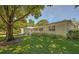 Side view of the house showing additional landscaping and a tree-lined street at 7331 Westmoreland Dr, Sarasota, FL 34243