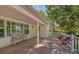Brick paved porch with a wooden bench, and lush greenery at 7331 Westmoreland Dr, Sarasota, FL 34243