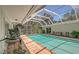 Large screened-in pool with brick pavers and lush landscaping at 7331 Westmoreland Dr, Sarasota, FL 34243