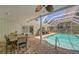 Inviting, screened-in pool area with brick pavers and dining area at 7331 Westmoreland Dr, Sarasota, FL 34243