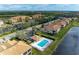 Aerial view of community pool, residential buildings, and parking at 8105 Grand Estuary Trl # 307, Bradenton, FL 34212